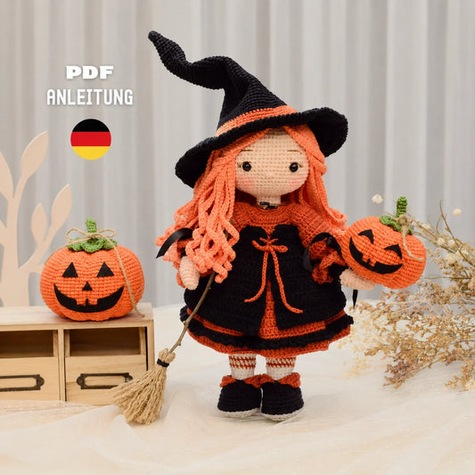 Beatrix the crocheted Halloween witch amigurumi with black hat and orange hair