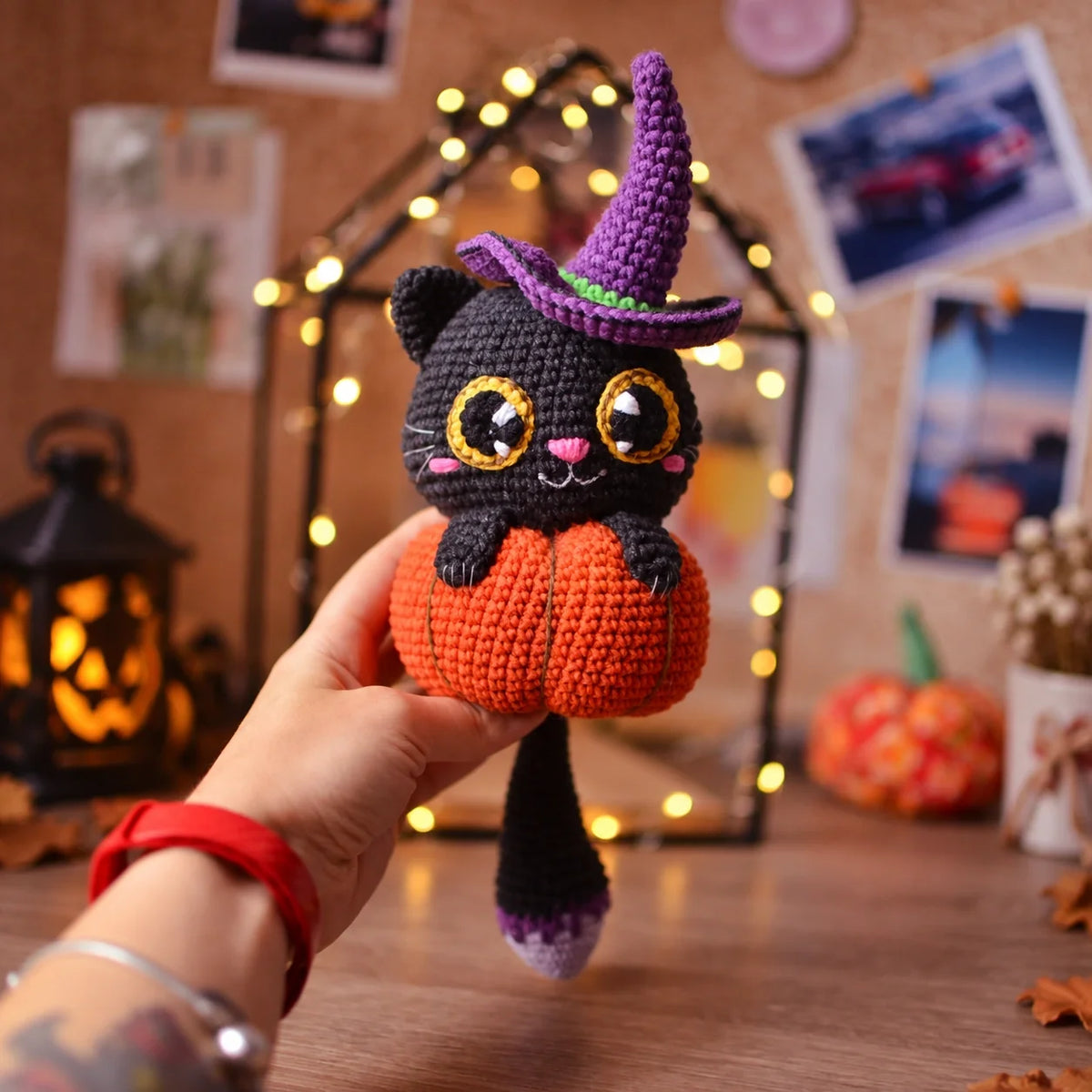 Crocheted Halloween cat in pumpkin displayed as seasonal decor