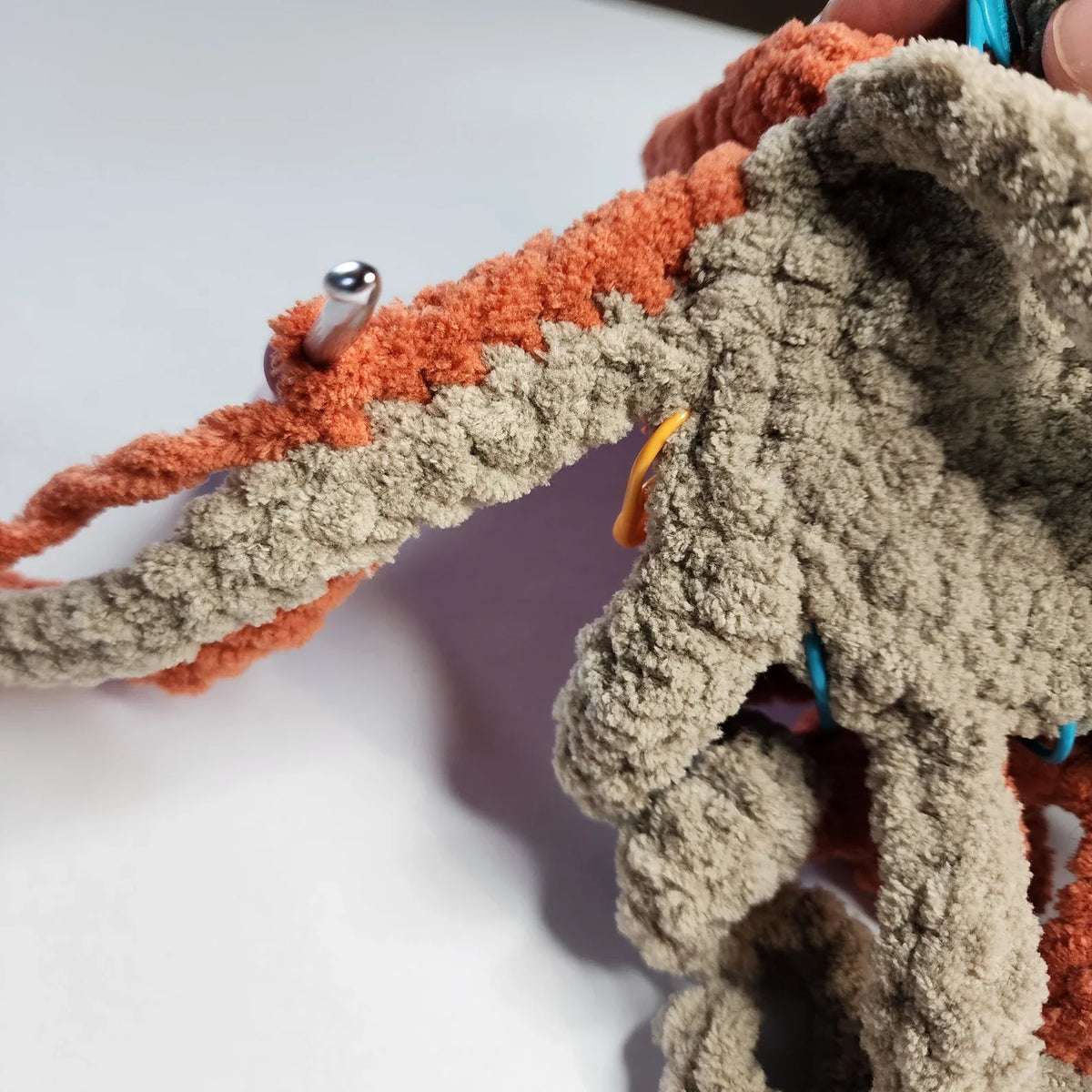 Finished crochet octopus toy on a neutral background
