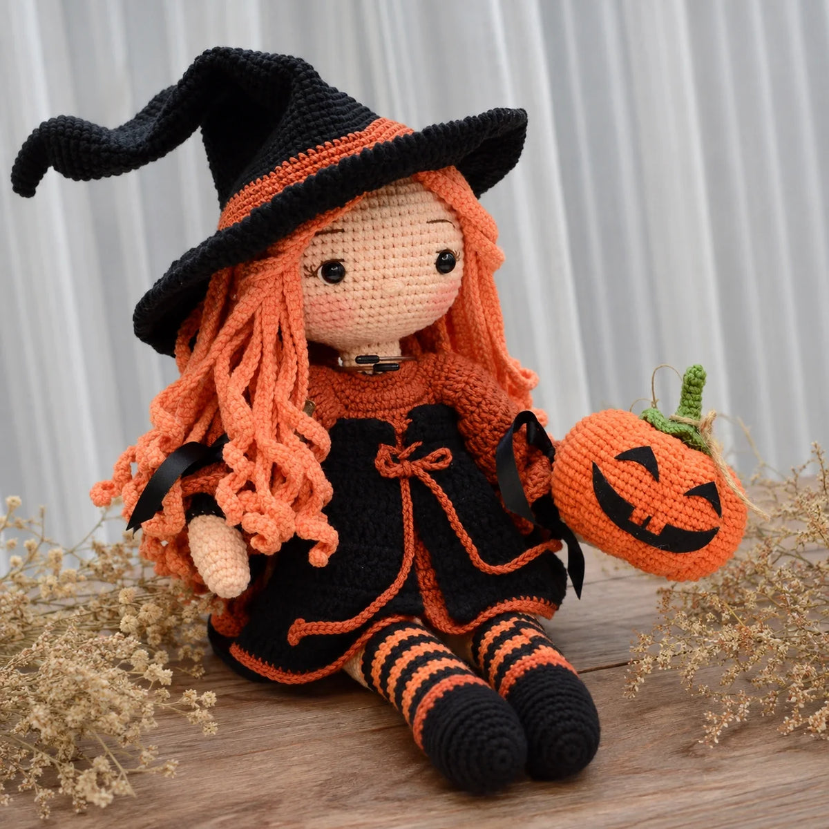 Crocheted Halloween witch Beatrix with long orange hair and pumpkin details