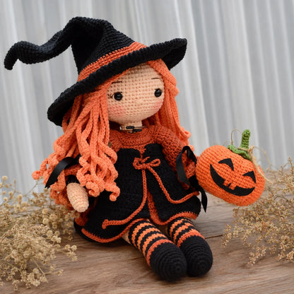 Crocheted Halloween witch Beatrix with long orange hair and pumpkin details