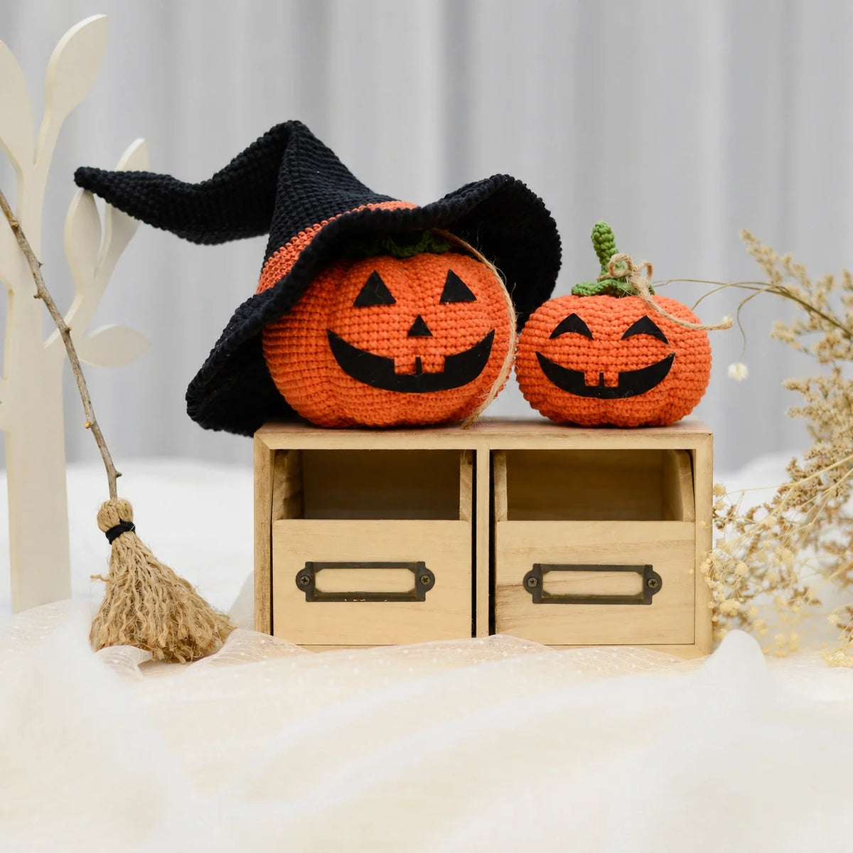 Orange crochet pumpkin with a smiling Halloween face
