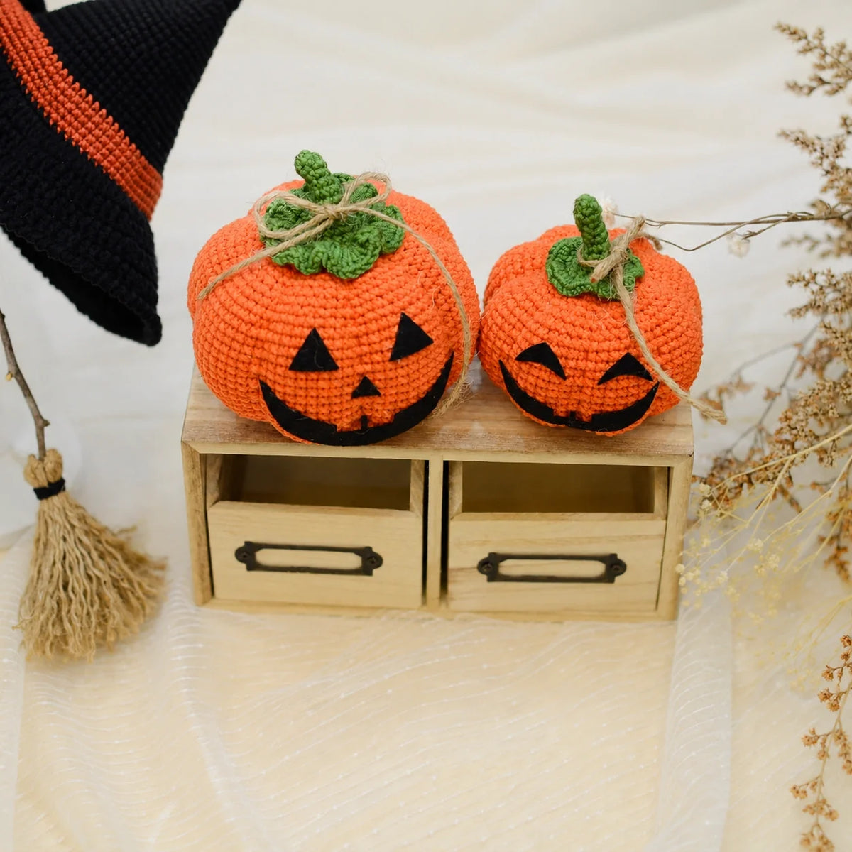 Close-up of a crochet pumpkin's stitched Halloween face
