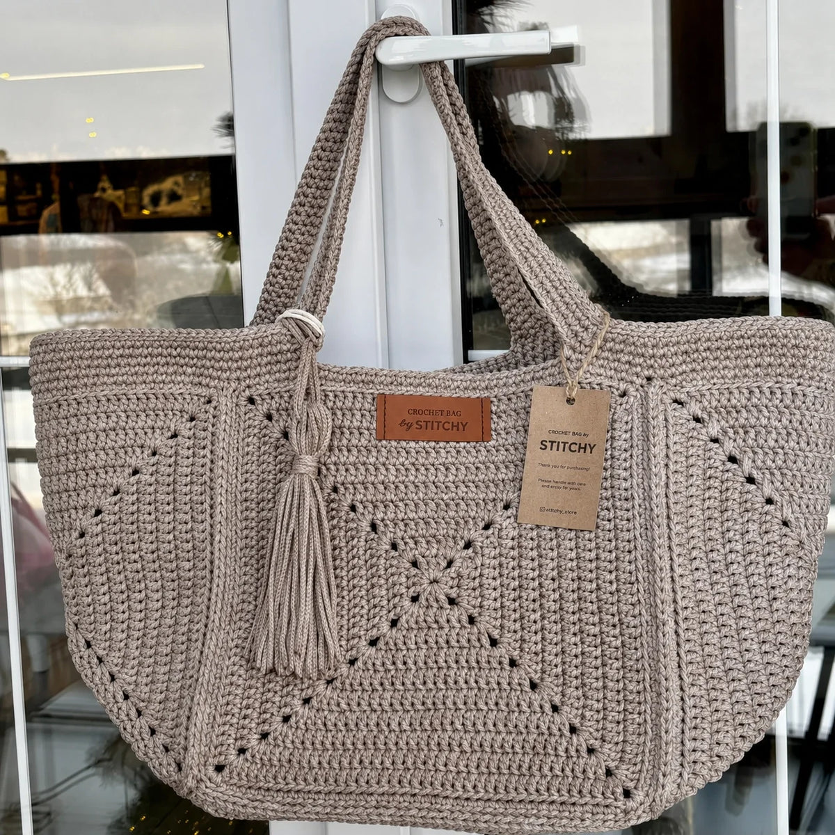 Handmade granny square tote used as a market bag