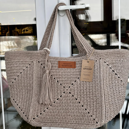 Handmade granny square tote used as a market bag