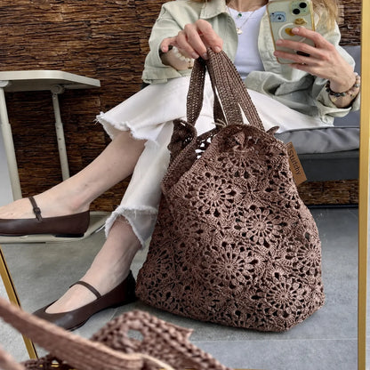 Close-up of the floral granny square motifs on the raffia bag