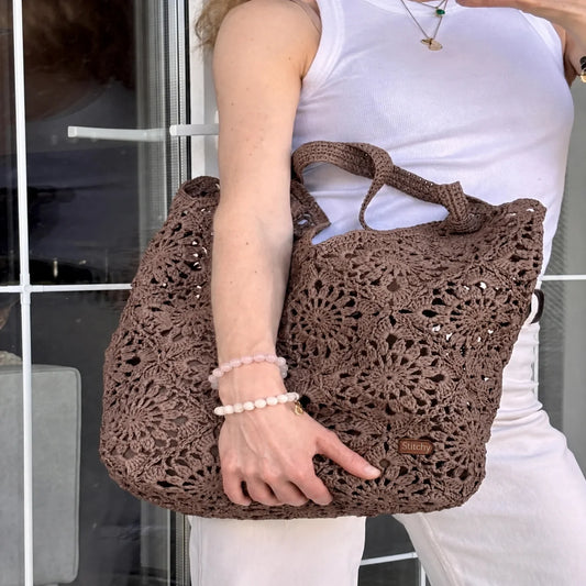 Crocheted raffia-look granny square tote bag with flower motifs