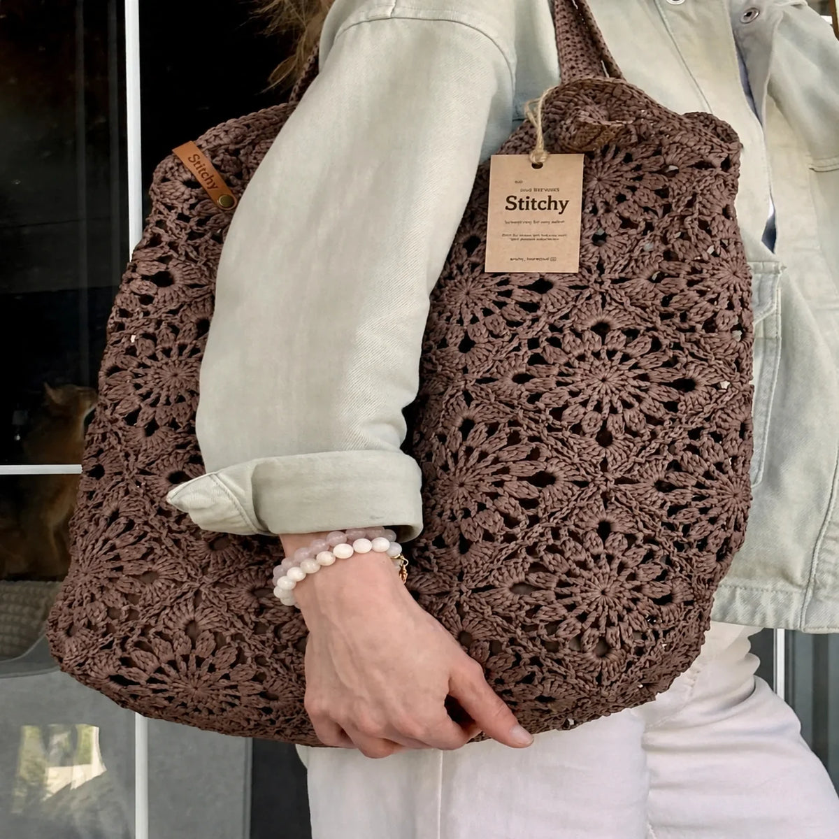 Raffia crochet bag with granny square pattern, side view