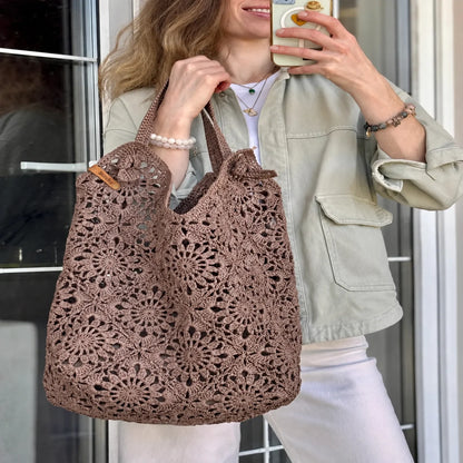 Roomy crocheted granny square tote filled with everyday items