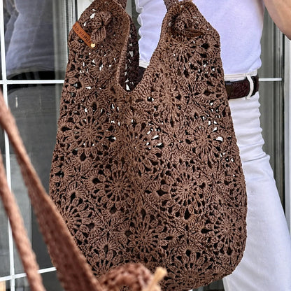 Raffia granny square crochet bag held in hand
