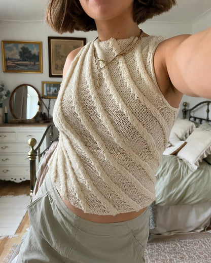Twister Tank knitted top with 3D spiral cables, front view on a model