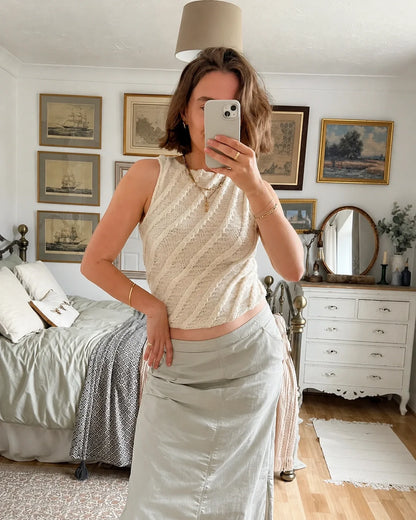 Longer version of the Twister Tank knitting pattern worn with jeans