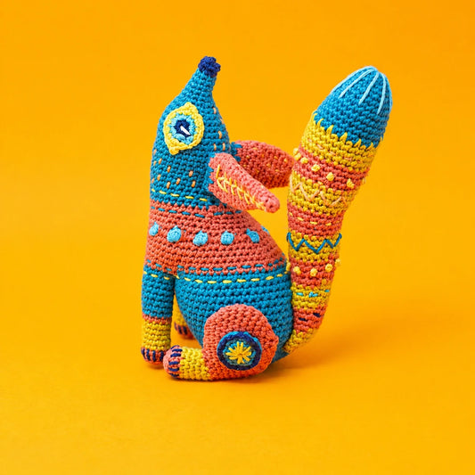 Colorful crocheted alebrije fox amigurumi with embroidered details