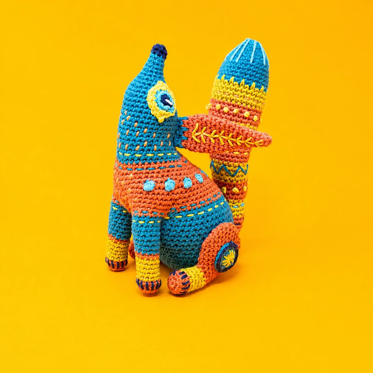 Close-up of the embroidered decorative patterns on the crochet fox