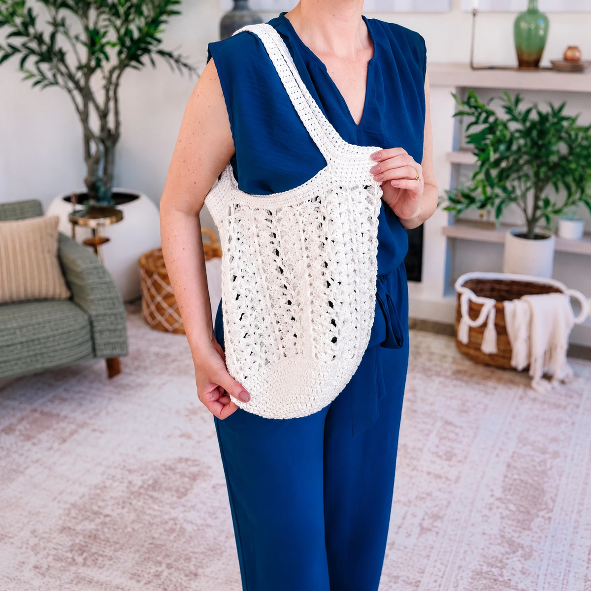 Crocheted mesh market bag laid flat, showing the handle