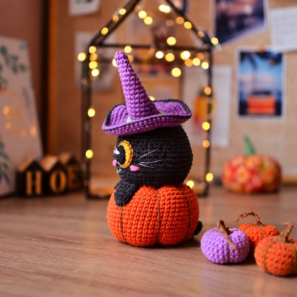 Side view of the crocheted pumpkin with cat and witch hat