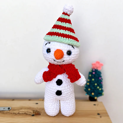 Crocheted snowman amigurumi with scarf and hat