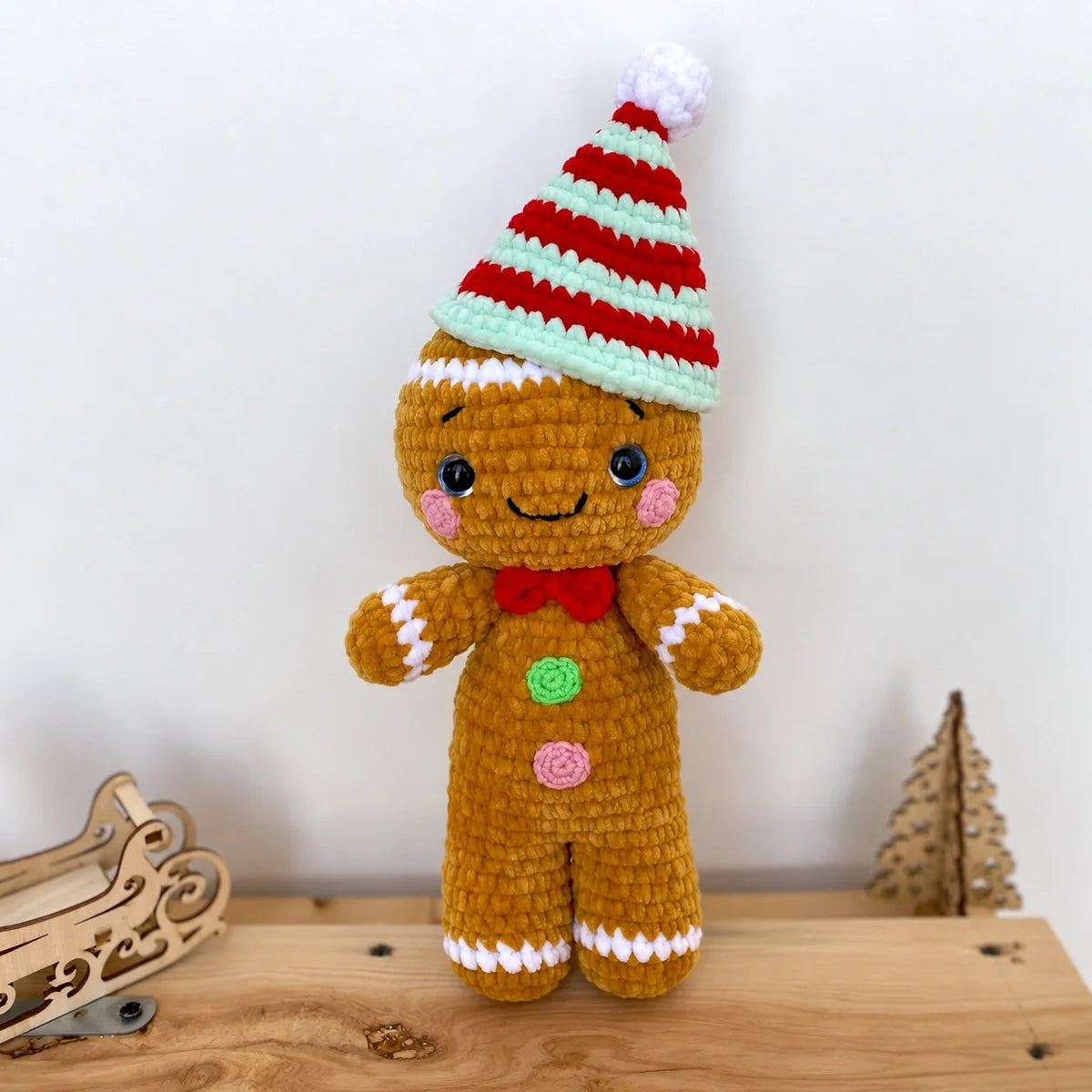 Handmade crochet reindeer and snowman next to holiday decorations