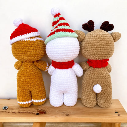 Crocheted gingerbread man and reindeer amigurumi under a Christmas tree