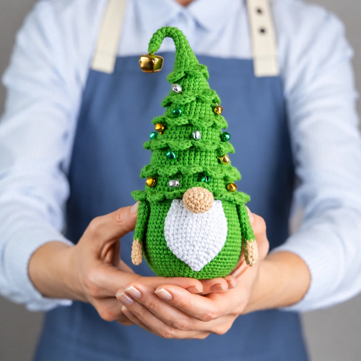 Side view of the crochet gnome showing the layered evergreen texture