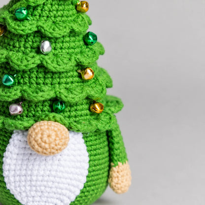 Crochet Christmas gnome next to holiday decorations