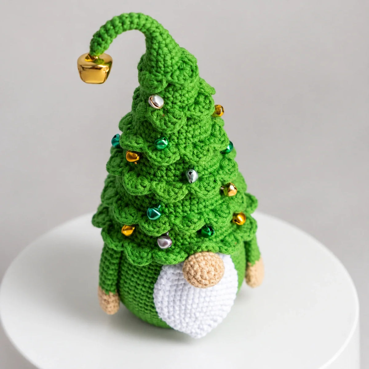 Christmas tree gnome crochet pattern finished piece on a wooden surface