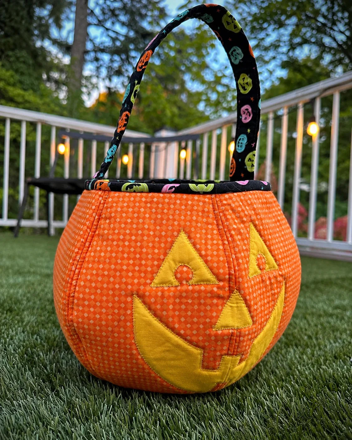 Quilted orange pumpkin candy bag with appliquéd face and fabric handle