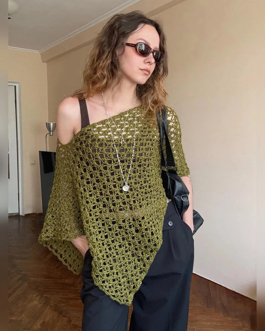 Light blue NOA crochet poncho top with open lace stitch, worn by a model