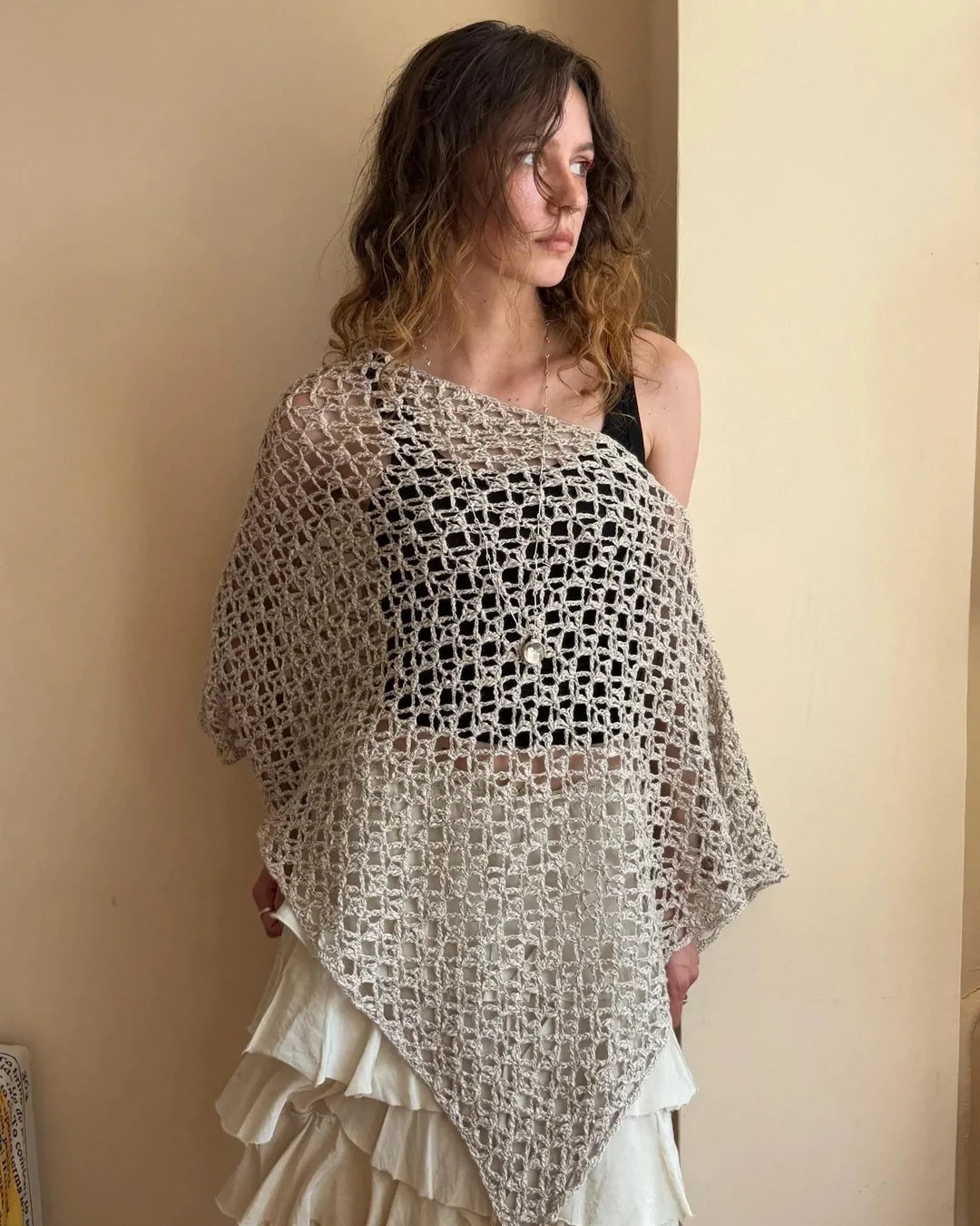 NOA crochet poncho top layered over a summer outfit