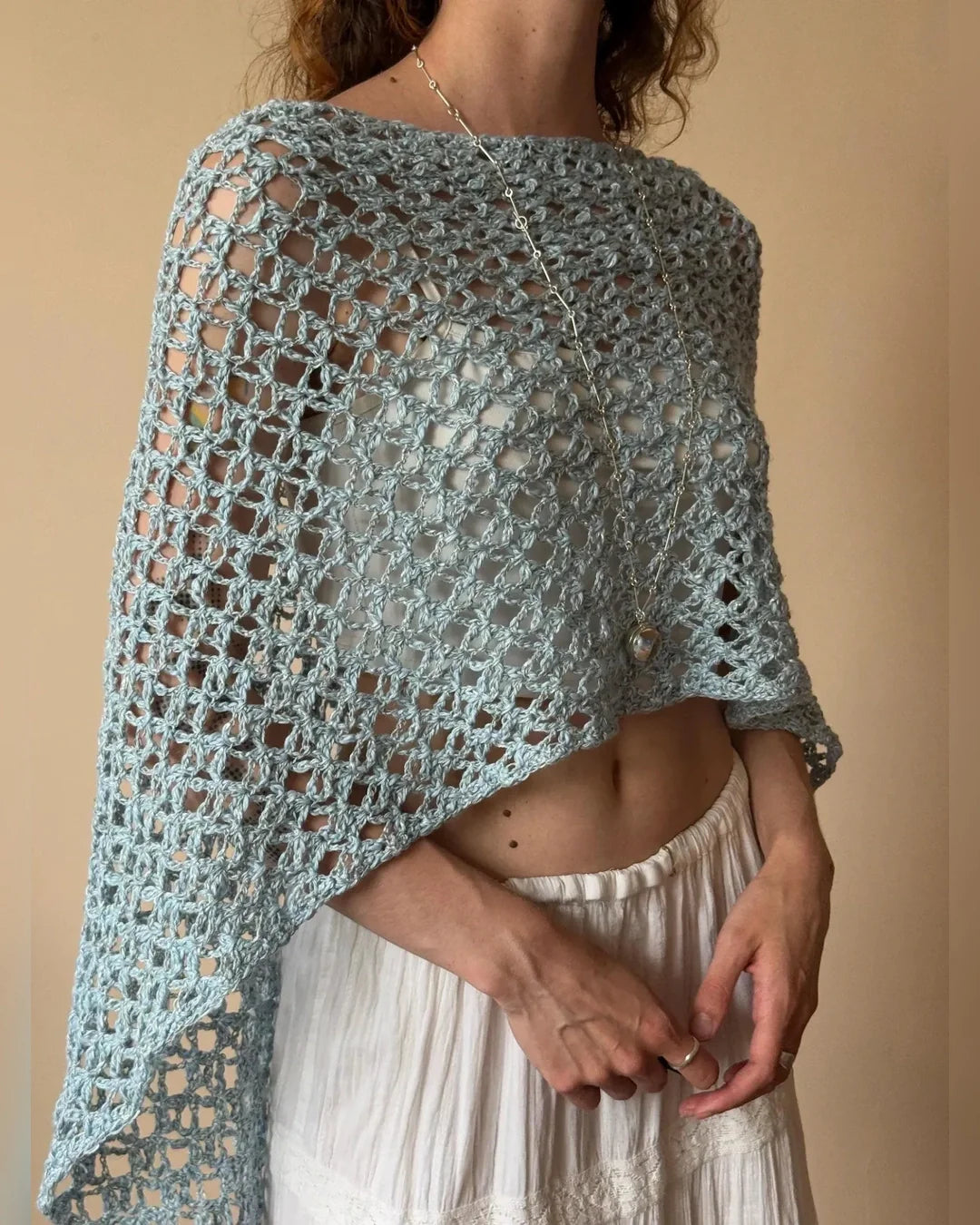 Airy NOA crochet poncho top in light blue with open mesh pattern