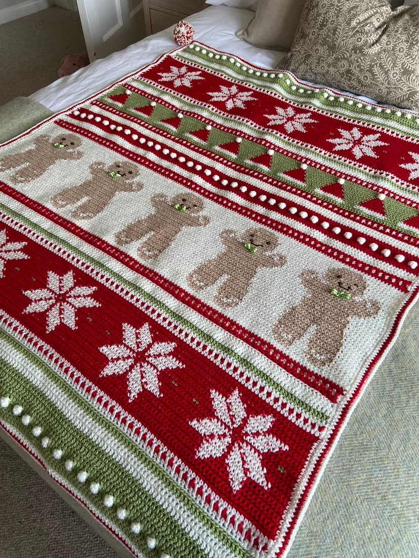 Christmas blanket with snowflake panels and pom-pom corners