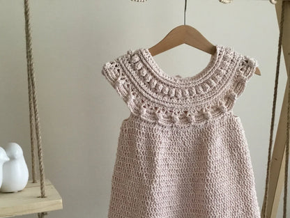 Close-up of the ruffles and decorative stitches on the baby dress