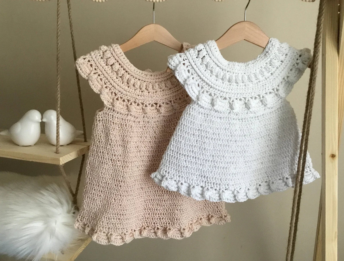 Baby wearing the Moonpetal ruffled crochet dress