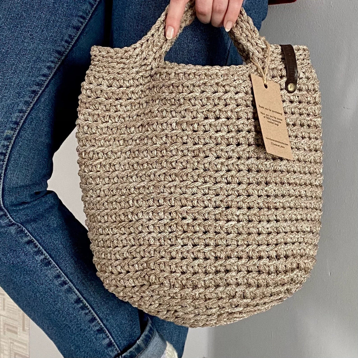 Crocheted tote bag filled with everyday essentials