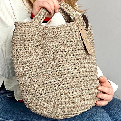 Crochet tote bag shown with handles, side view