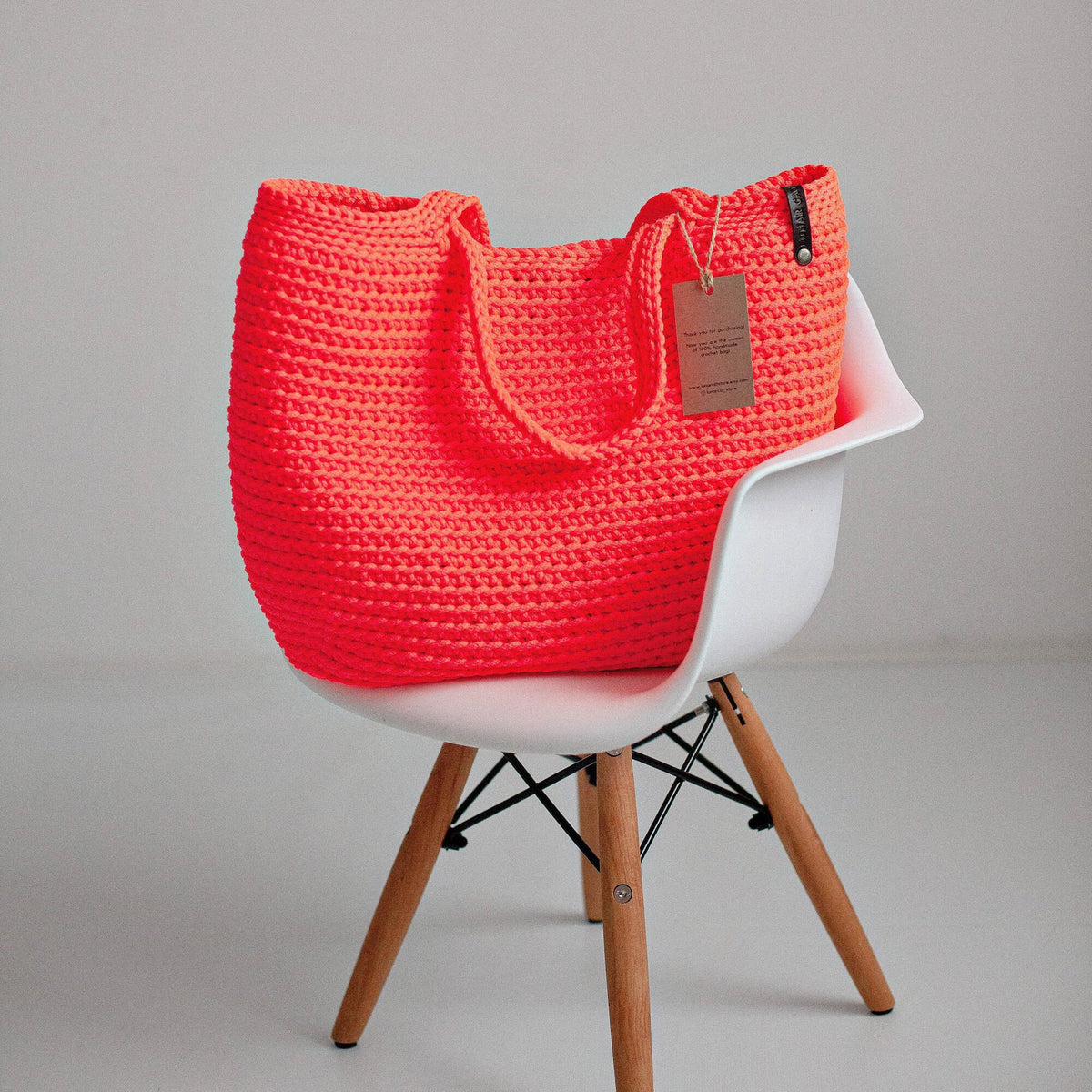 Model carrying the oversized crochet tote bag