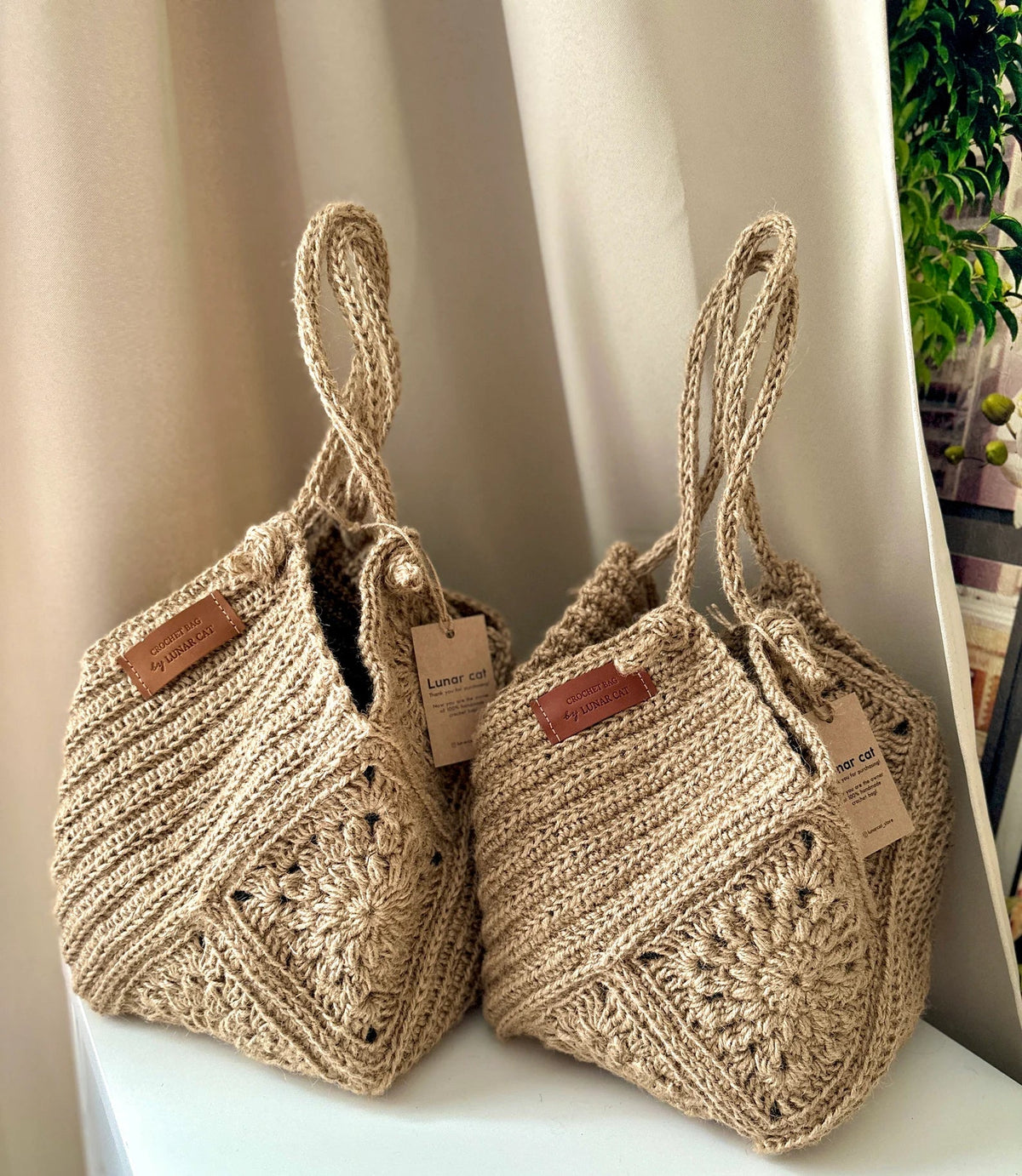 Woman carrying a crocheted jute hobo bag