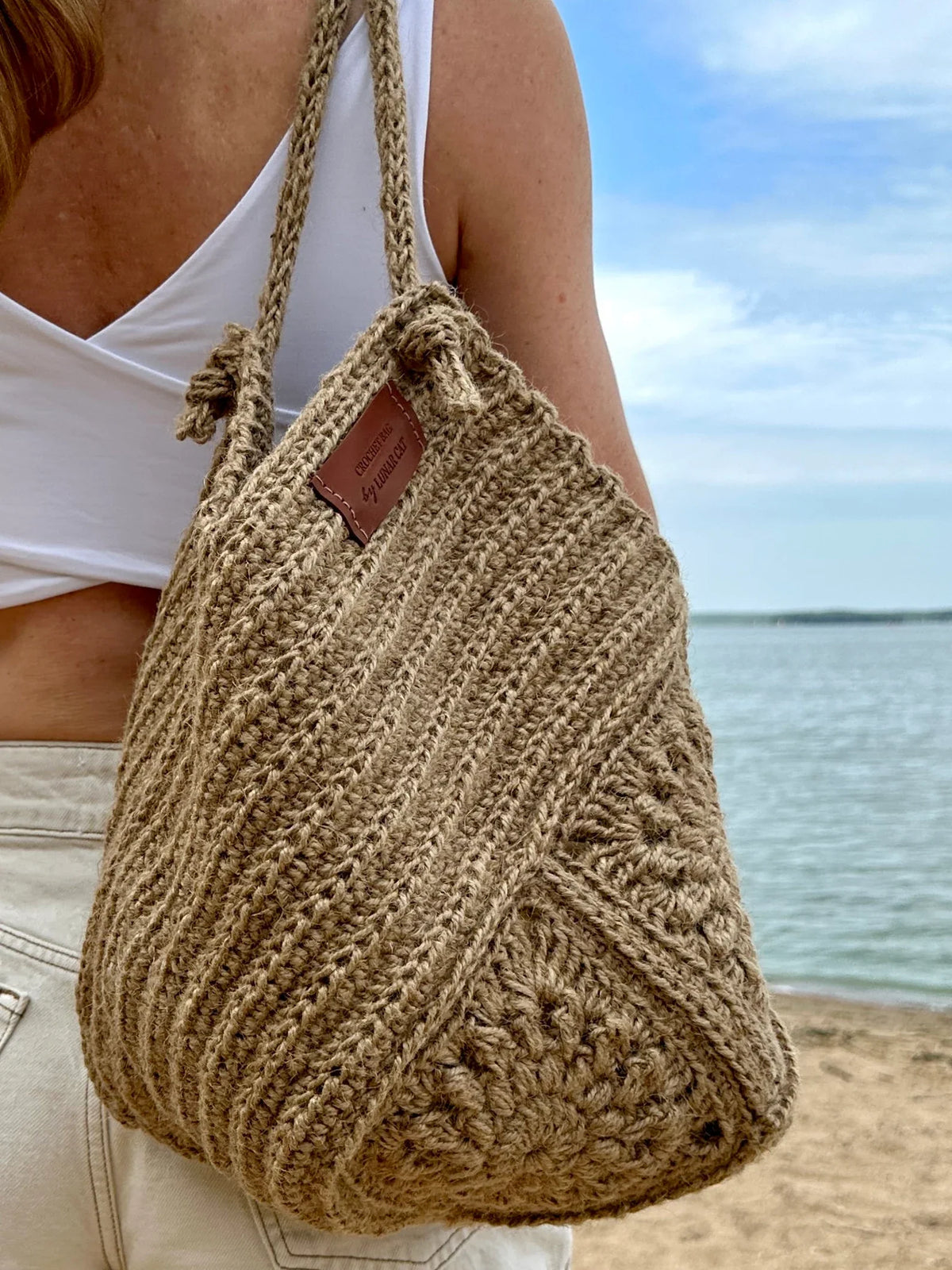 Jute granny square crochet bag on a neutral background