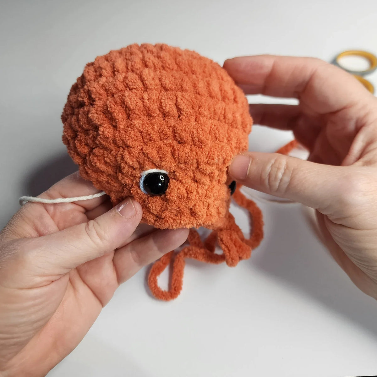 Two amigurumi octopuses in pink and beige