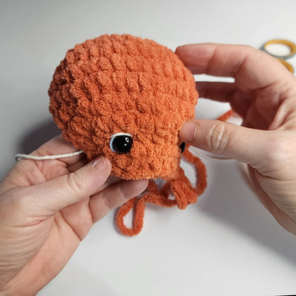 Two amigurumi octopuses in pink and beige
