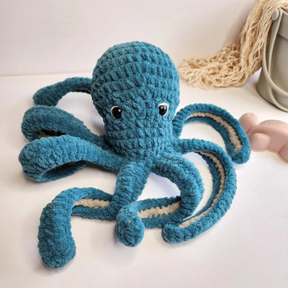 Soft crocheted octopus displayed on a shelf
