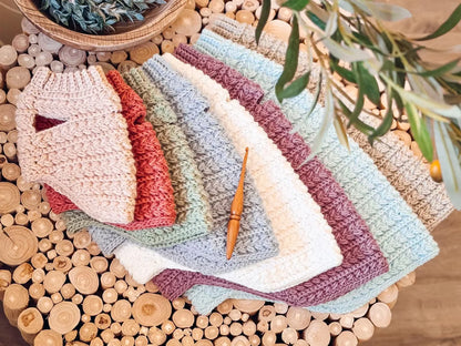 Crocheted dog sweaters in different sizes and colors