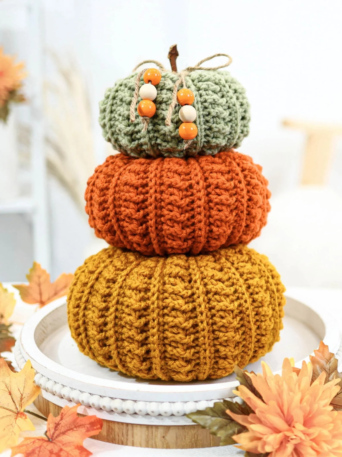 Stack of crocheted pumpkins in rustic farmhouse style