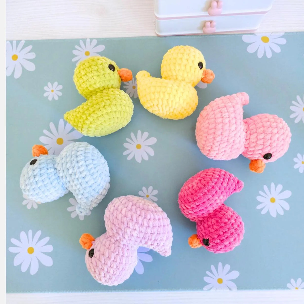 Close-up of a crochet duck showing beak and safety eyes