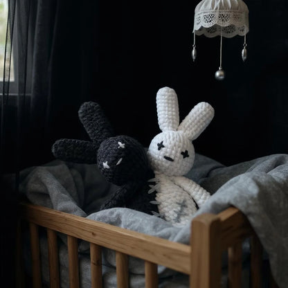 Two-headed crochet bunny with contrasting light and dark heads
