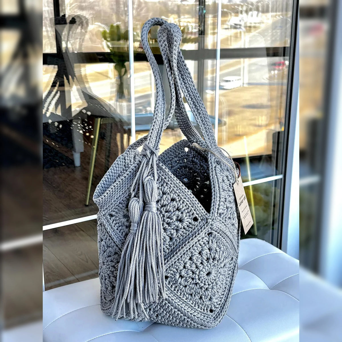 Detail of the tassel charm on the crochet market bag