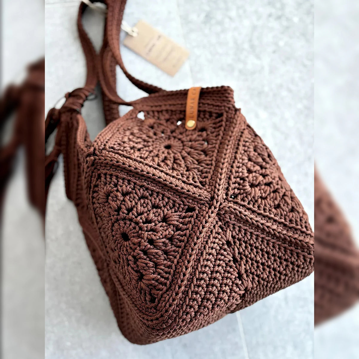 Granny square market bag with tassel, close-up of handle