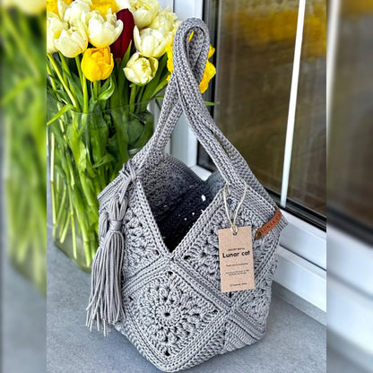 Granny square market bag on a neutral background, product shot