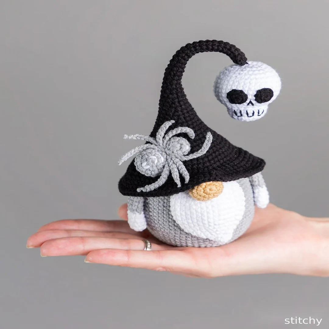 Crochet Halloween gnome displayed with fall decorations