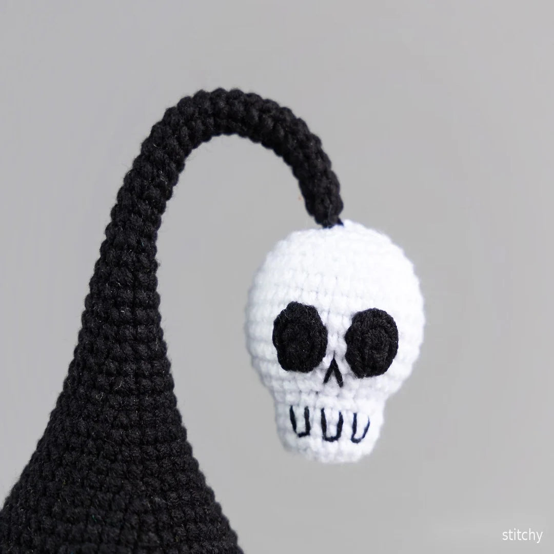 Halloween gnome amigurumi on a shelf as seasonal decor